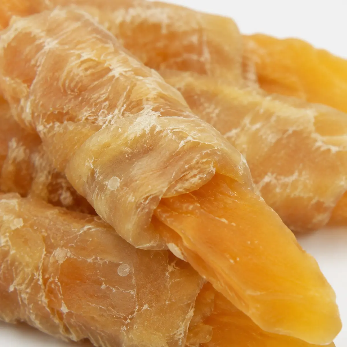 Close-up of chicken wrapped sweet potato strips showing the wrapped texture and natural orange sweet potato color — view 2