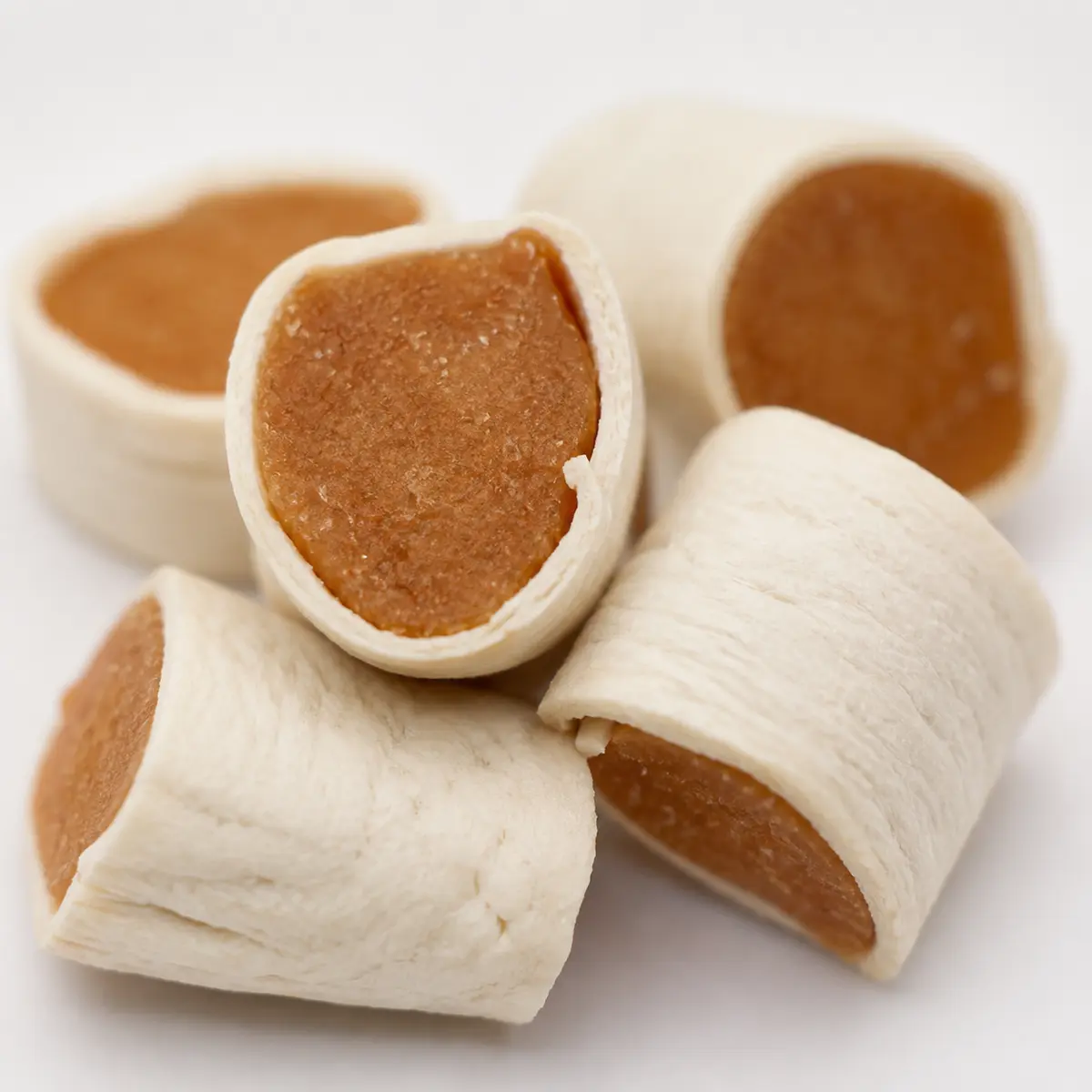 Close-up of heart-shaped chicken heart roll treats showing texture and dual protein blend — view 2