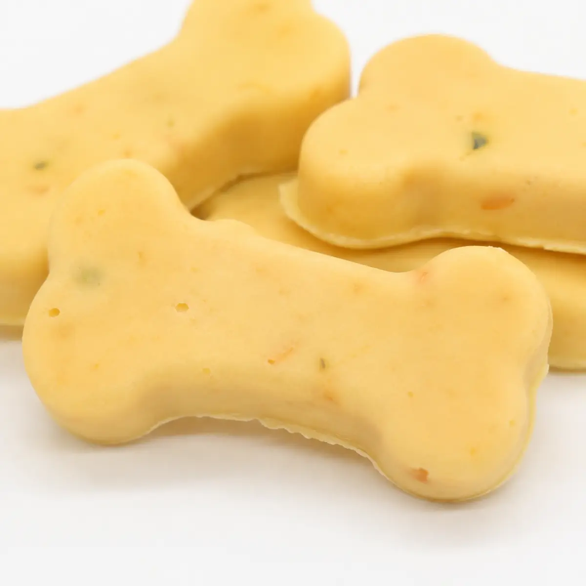 Close-up of bone-shaped cheese bone treats showing 13g piece size and texture — view 2