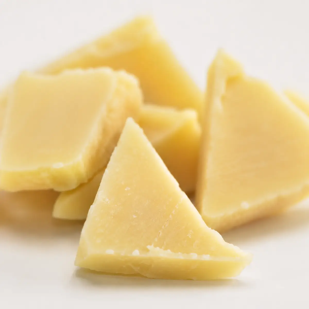 Close-up of triangle-cut treats showing cheese and chicken texture — view 2
