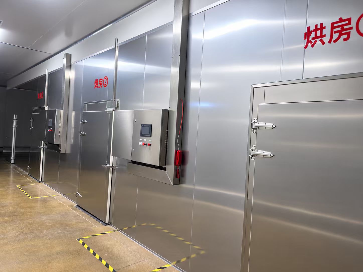 Inside a China pet-treat production facility — drying room with two heat-treatment ovens.